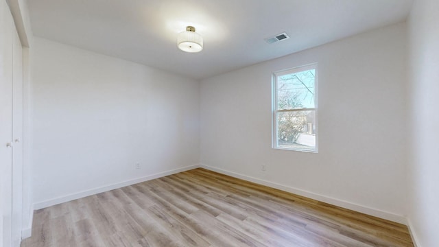 spare room with light hardwood / wood-style flooring