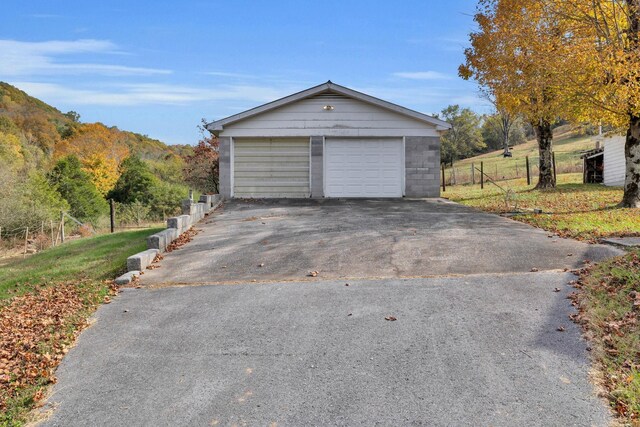 garage with a rural view and a mountain view