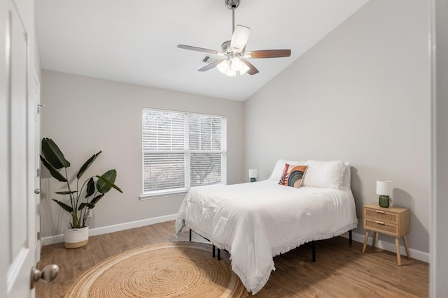 bedroom featuring ceiling fan, light hardwood / wood-style flooring, and vaulted ceiling