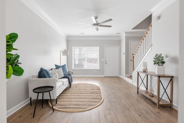 sitting room featuring ceiling fan, light hardwood / wood-style flooring, and ornamental molding