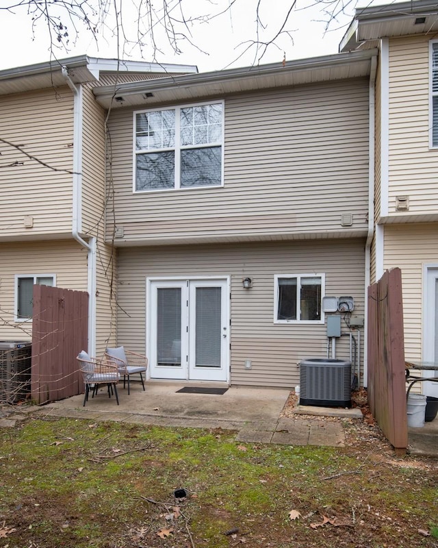 rear view of property featuring french doors, central AC unit, and a patio area