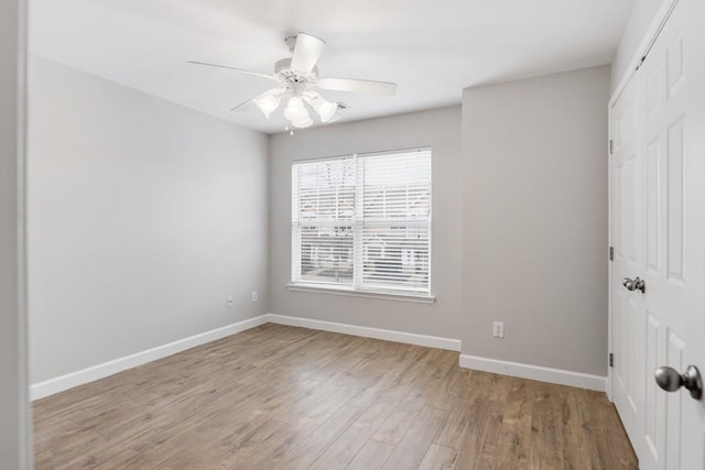 empty room featuring light hardwood / wood-style flooring and ceiling fan