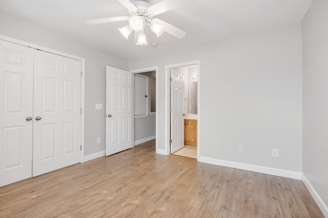 unfurnished bedroom featuring ceiling fan, a closet, light hardwood / wood-style flooring, and ensuite bath