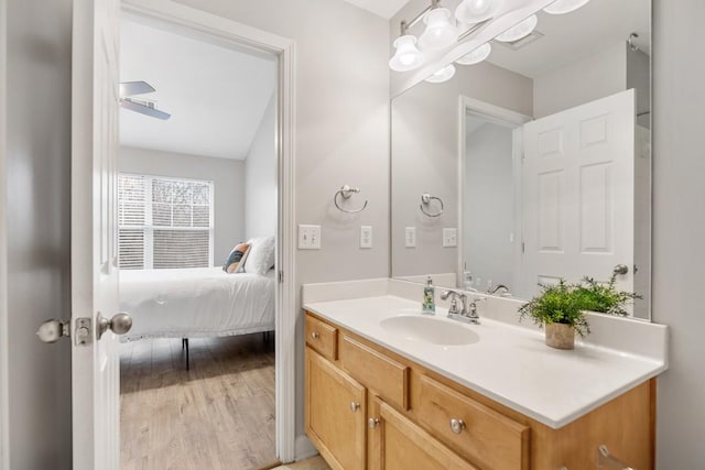 bathroom featuring hardwood / wood-style floors, vanity, and ceiling fan