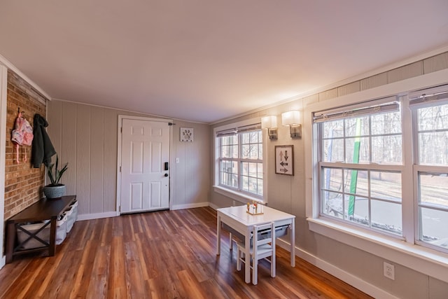 foyer featuring crown molding and dark wood-type flooring