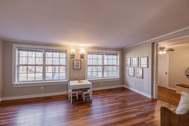 unfurnished office featuring dark hardwood / wood-style flooring, ceiling fan, and crown molding