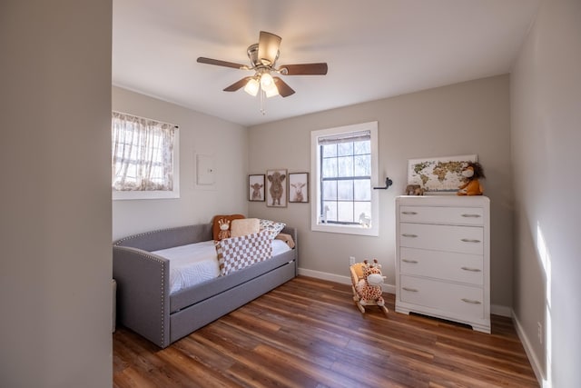 bedroom with ceiling fan and dark hardwood / wood-style flooring