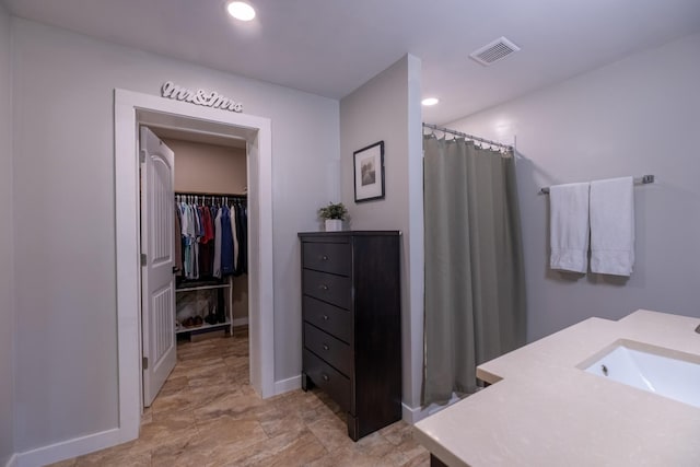 bathroom with vanity and curtained shower