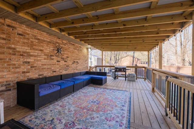 wooden terrace with outdoor lounge area and a grill