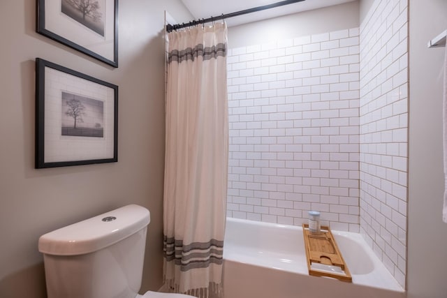 bathroom featuring shower / bath combo and toilet