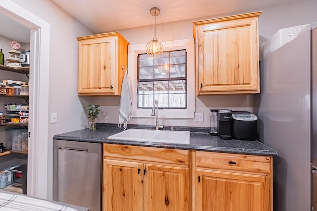 kitchen with appliances with stainless steel finishes, light brown cabinets, pendant lighting, and sink