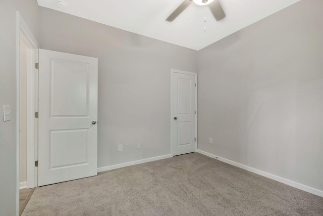 carpeted empty room featuring ceiling fan