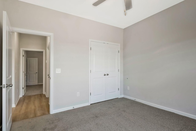 unfurnished bedroom with carpet flooring, ceiling fan, and a closet