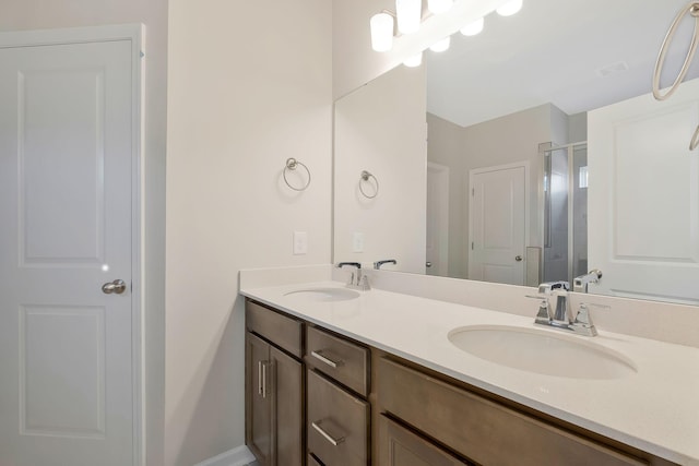 bathroom with vanity and a shower with door