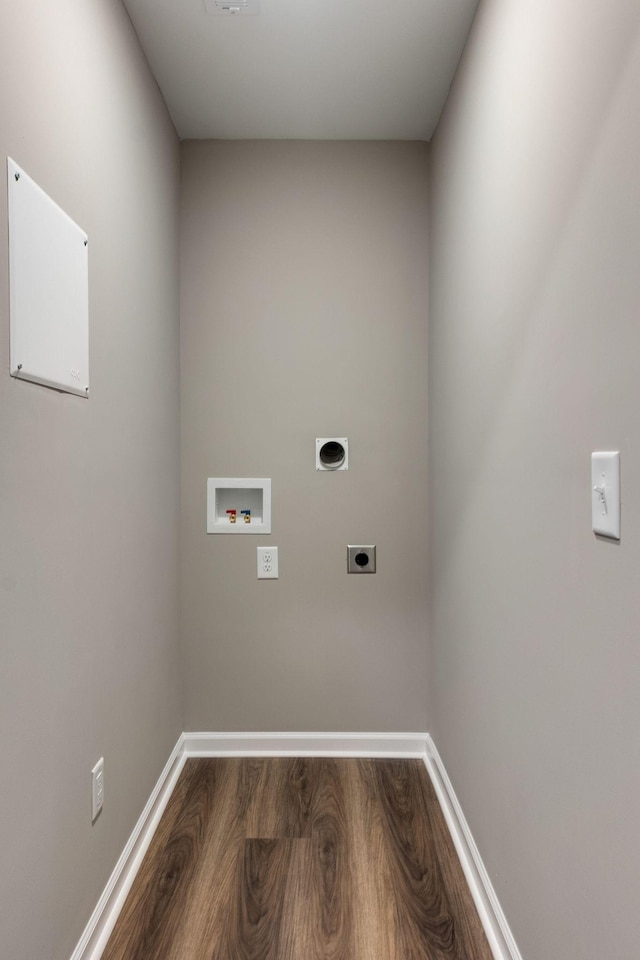 washroom with hookup for an electric dryer, hardwood / wood-style flooring, and hookup for a washing machine