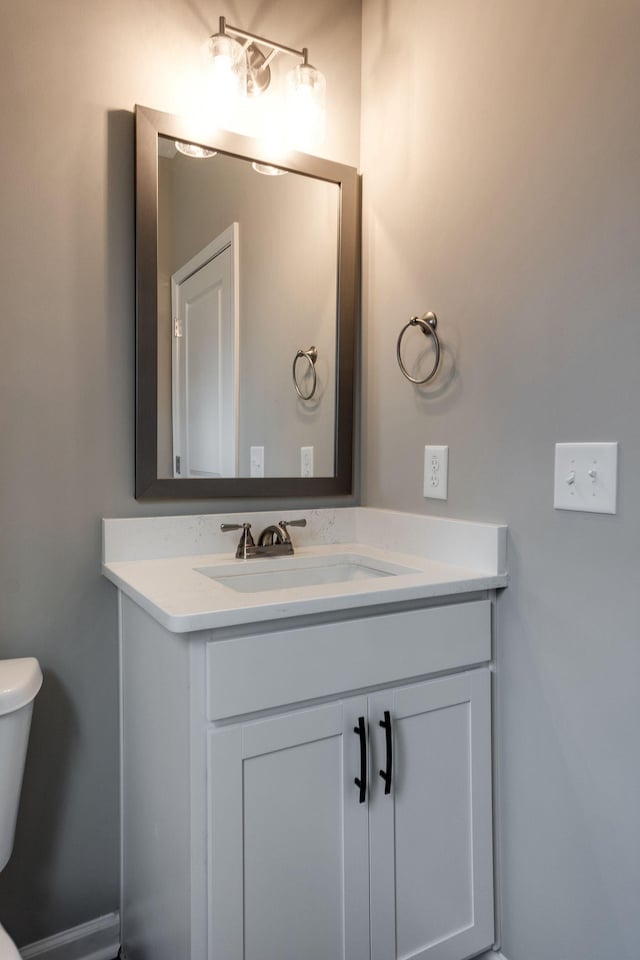 bathroom featuring vanity and toilet