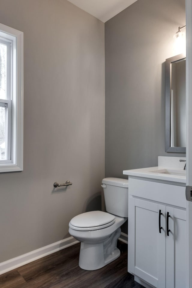 bathroom featuring hardwood / wood-style flooring, vanity, and toilet