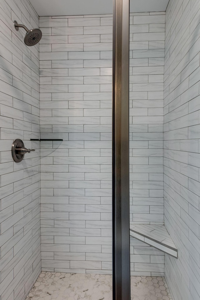 bathroom with a tile shower