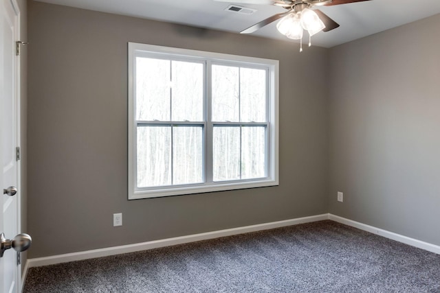 carpeted spare room with ceiling fan