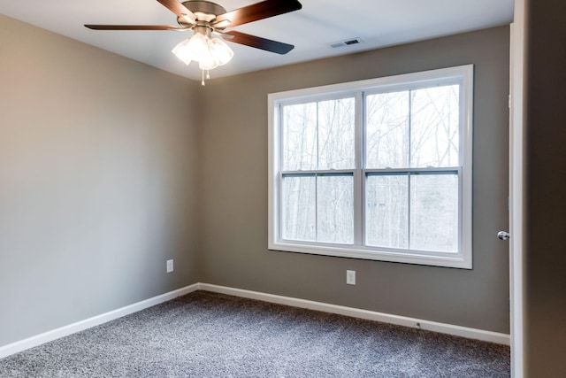 carpeted spare room featuring ceiling fan