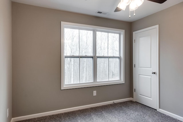 carpeted spare room with ceiling fan