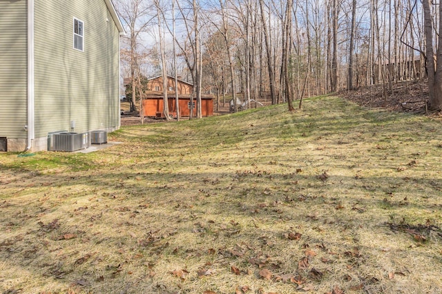 view of yard with an outbuilding and central air condition unit