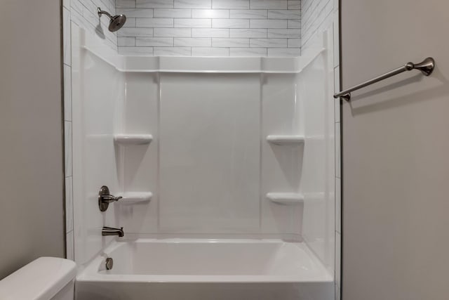 bathroom with toilet and washtub / shower combination