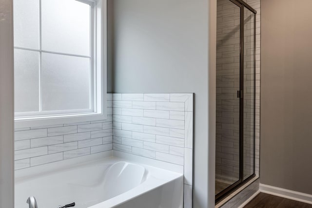 bathroom with hardwood / wood-style floors and plus walk in shower