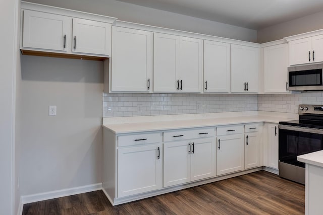 kitchen featuring white cabinetry, stainless steel appliances, dark wood-type flooring, and tasteful backsplash