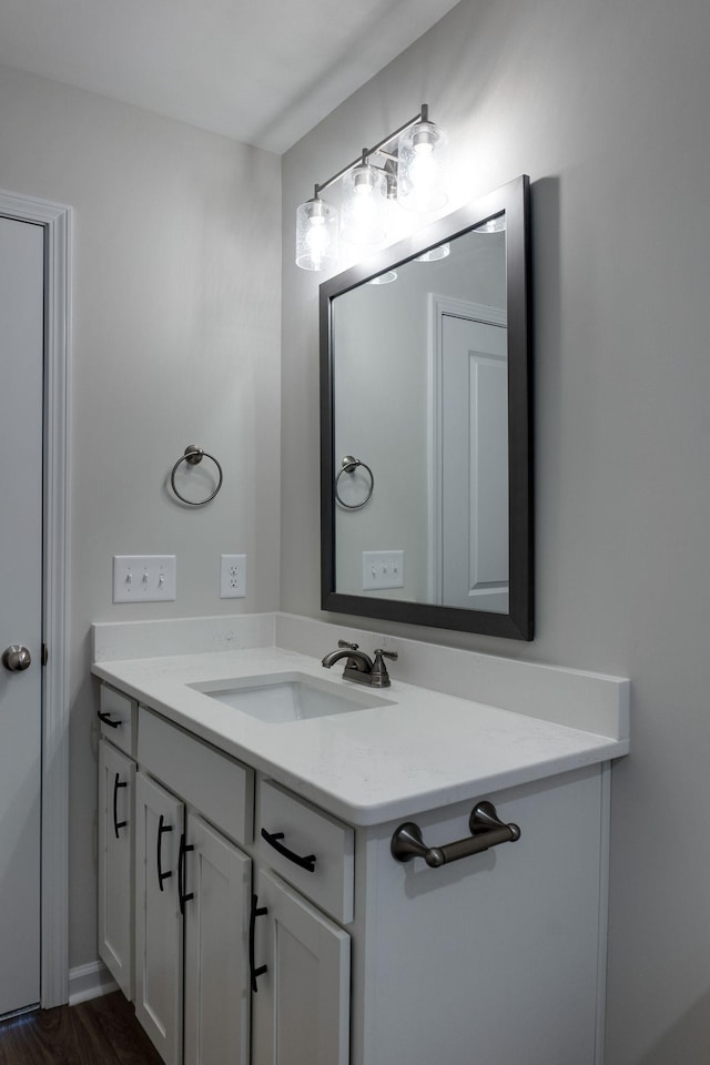 bathroom with hardwood / wood-style floors and vanity