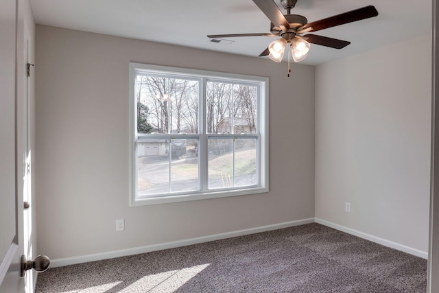 carpeted spare room featuring ceiling fan