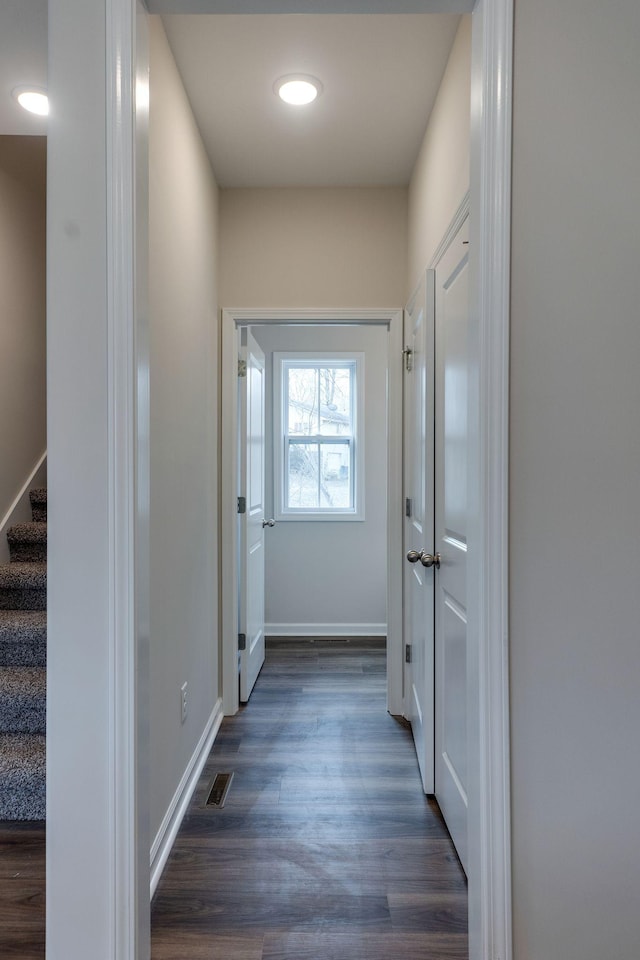 corridor with dark hardwood / wood-style floors