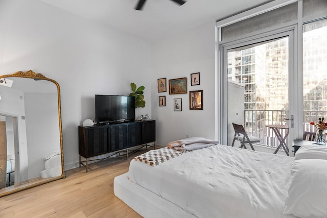 bedroom with access to outside, ceiling fan, and wood-type flooring