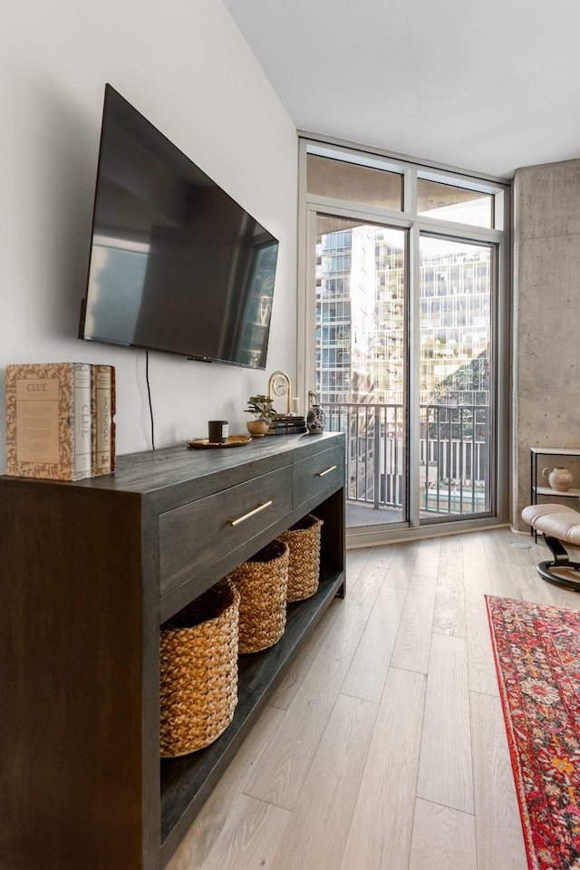 interior space with light hardwood / wood-style floors and a wall of windows