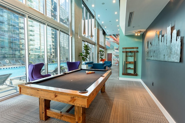 rec room with carpet, a high ceiling, and billiards