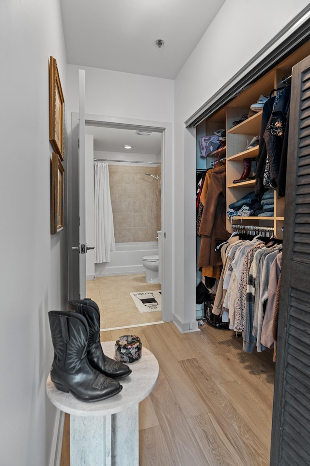 spacious closet featuring light wood-type flooring