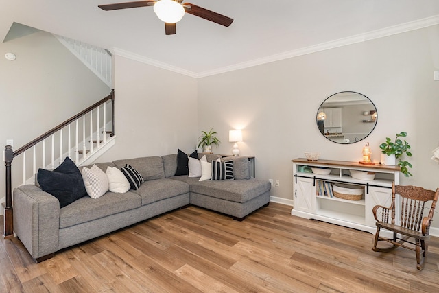 living room featuring ceiling fan, ornamental molding, and light hardwood / wood-style floors