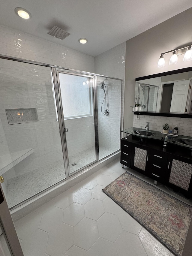 bathroom with walk in shower, tile patterned floors, vanity, and backsplash