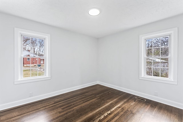 empty room with dark wood-type flooring