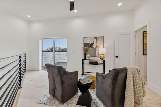 living room featuring ceiling fan and light hardwood / wood-style flooring