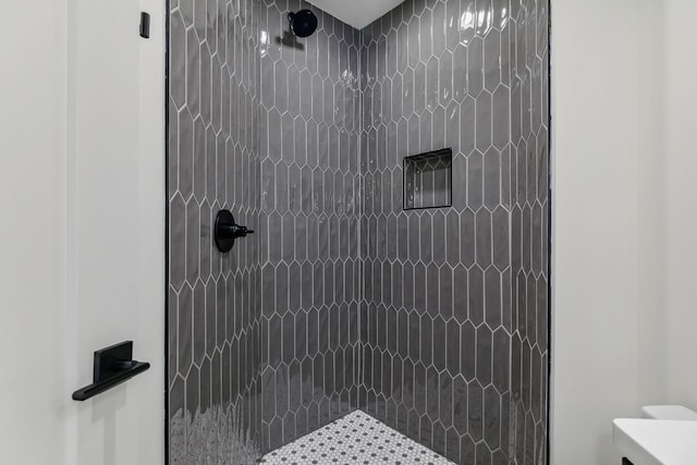 bathroom featuring toilet and walk in shower