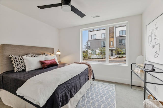 bedroom with light colored carpet and ceiling fan