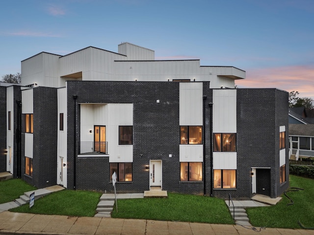 contemporary home featuring a lawn