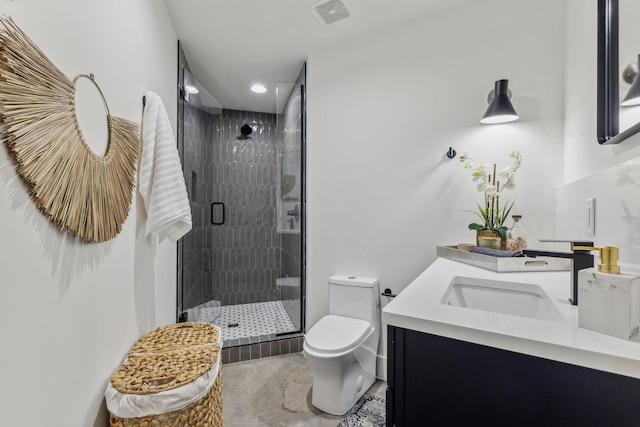 bathroom featuring an enclosed shower, vanity, and toilet