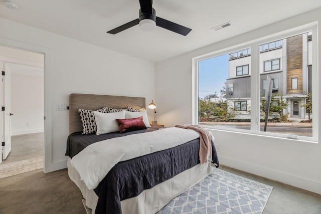 bedroom with ceiling fan and multiple windows