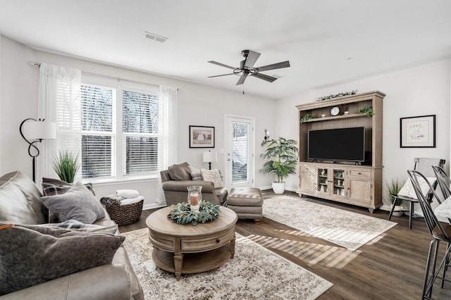 living room with ceiling fan and dark hardwood / wood-style floors