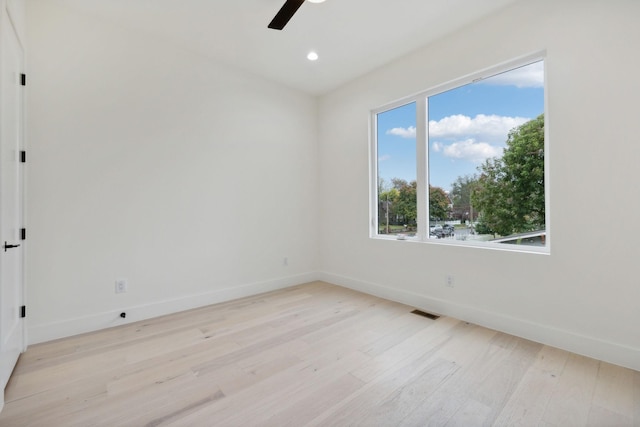 empty room featuring light hardwood / wood-style floors, a wealth of natural light, and ceiling fan