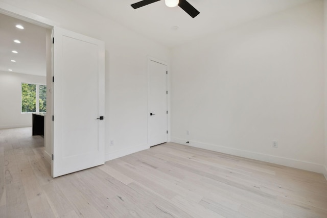 unfurnished bedroom featuring ceiling fan and light wood-type flooring