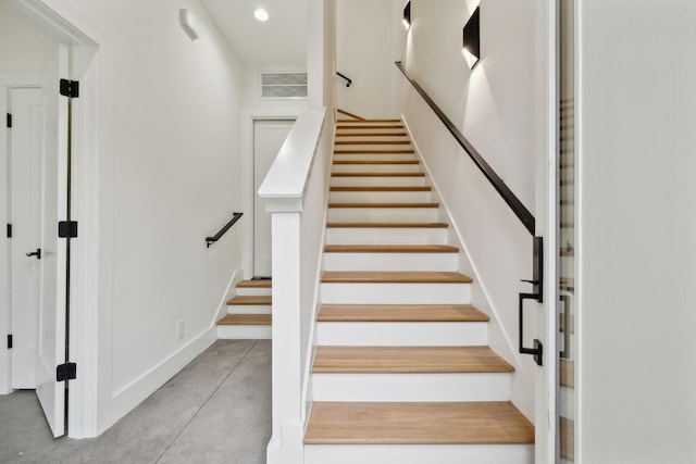 stairway with concrete floors