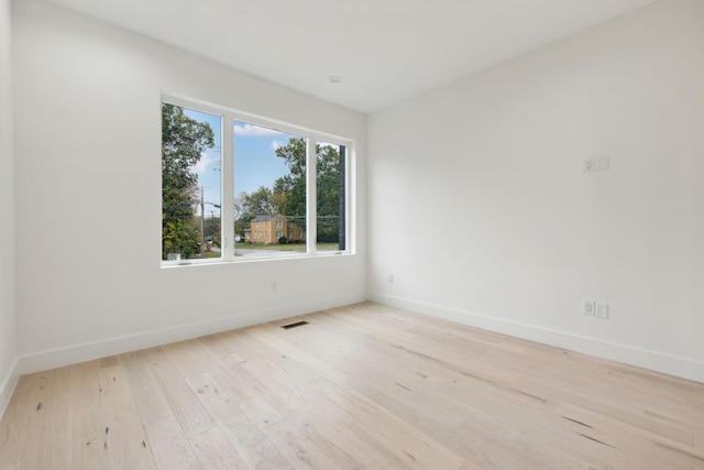 spare room featuring light hardwood / wood-style floors